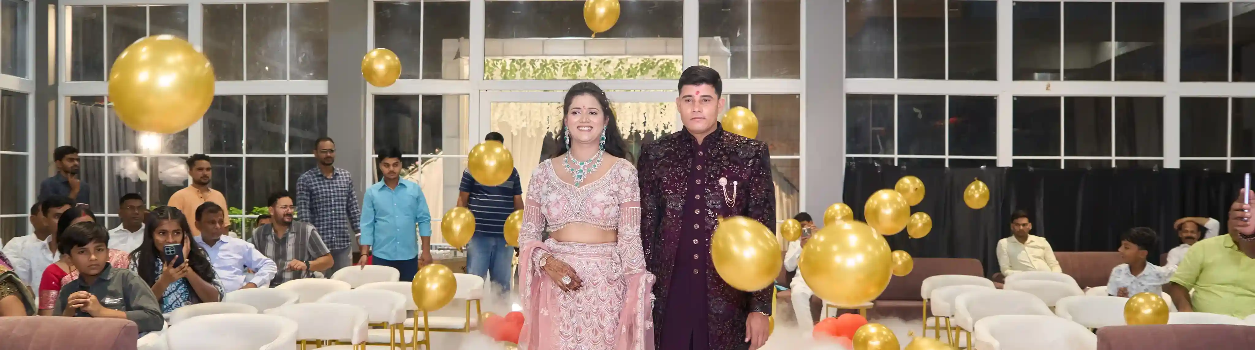 Sonu and Rashmi walking in through balloons and dry-ice fog at their Gokul Dham Lawn Varanasi engagement